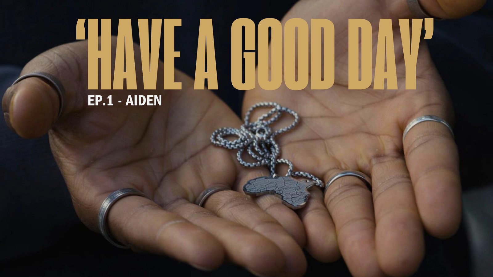 Have a Good Day title slide, episode one, a hand holding a silver necklace pendant