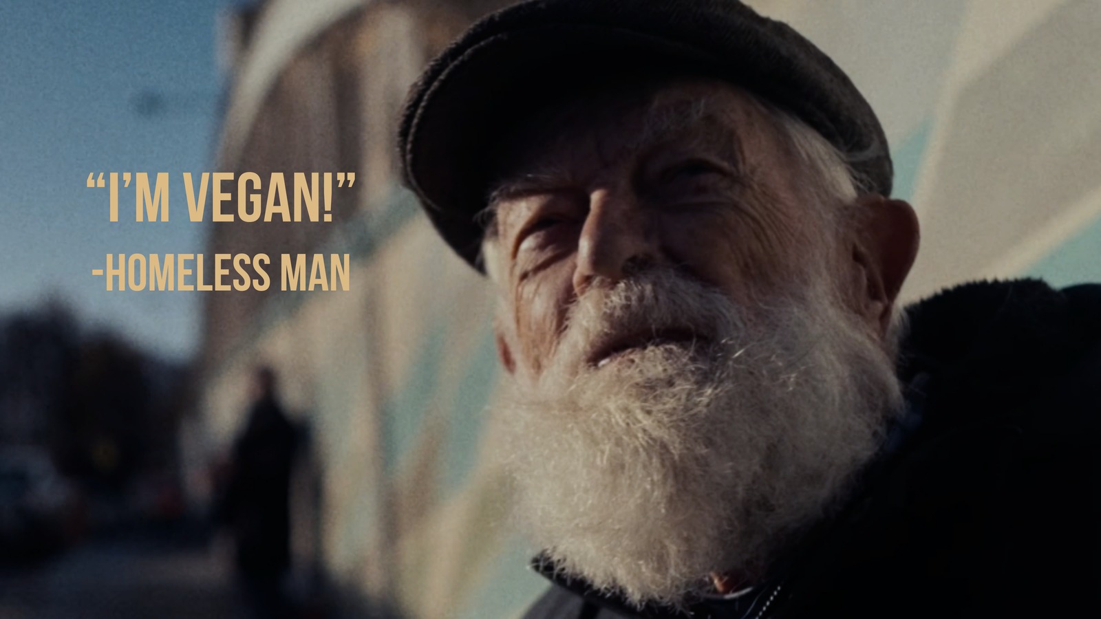Character quote slide, I'm vegan, attributed to Homeless Man, over a close up portrait